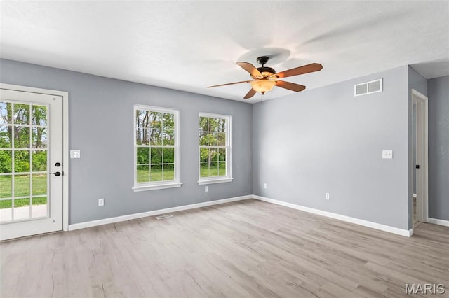 705 Fulton St, Gillespie, IL 62033 - unfurnished room featuring ceiling fan, plenty of natural light, wood finished floors, and baseboards