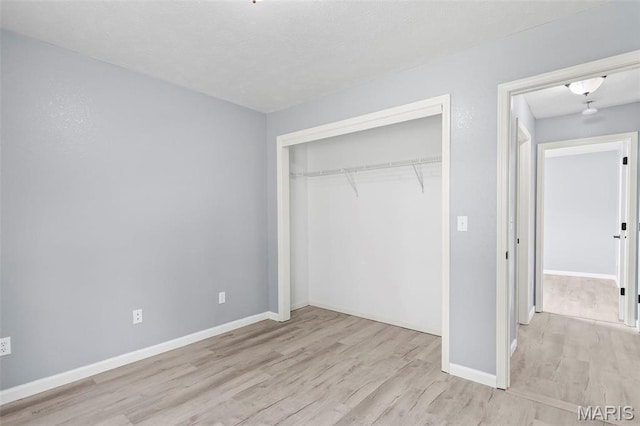 705 Fulton St, Gillespie, IL 62033 - unfurnished bedroom with wood finished floors, a closet, and baseboards
