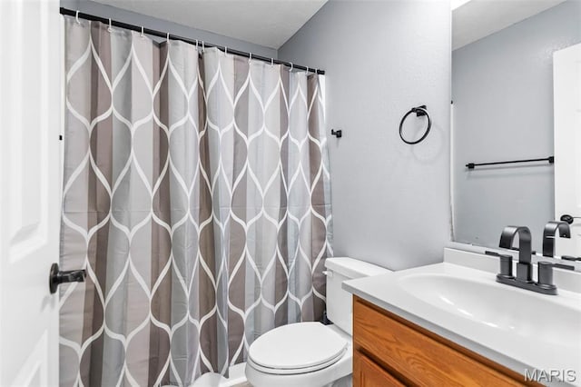 705 Fulton St, Gillespie, IL 62033 - bathroom with toilet, vanity, and curtained shower