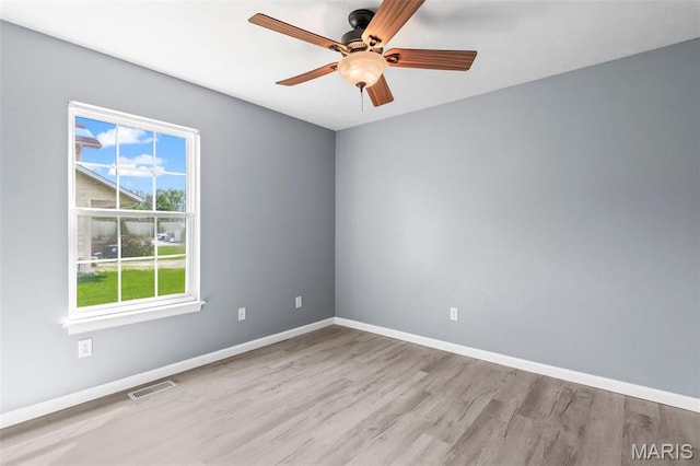 705 Fulton St, Gillespie, IL 62033 - spare room featuring wood finished floors, ceiling fan, and baseboards