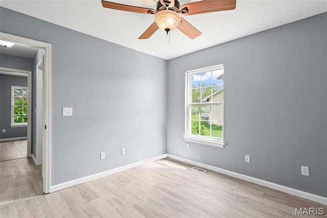 705 Fulton St, Gillespie, IL 62033 - empty room featuring healthy amount of natural light, wood finished floors, baseboards, and a ceiling fan