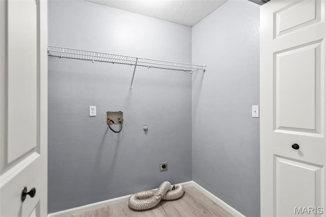 705 Fulton St, Gillespie, IL 62033 - washroom with electric dryer hookup, wood finished floors, hookup for a washing machine, and baseboards