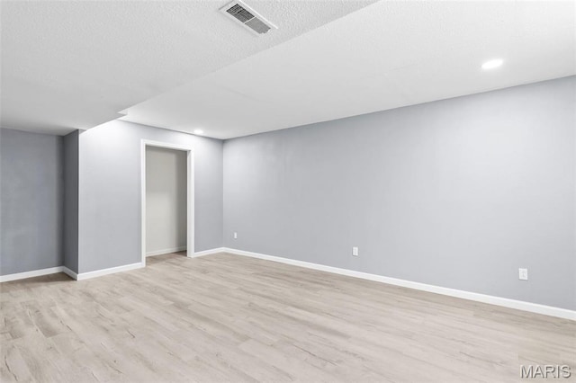 705 Fulton St, Gillespie, IL 62033 - finished below grade area with light wood-style floors, baseboards, recessed lighting, and a textured ceiling