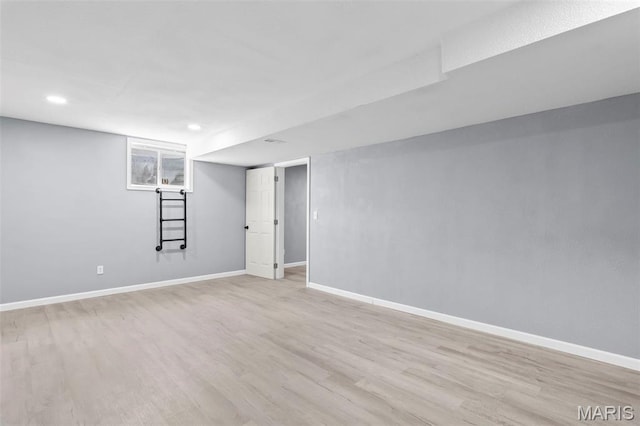 705 Fulton St, Gillespie, IL 62033 - finished below grade area with light wood-type flooring, baseboards, and recessed lighting