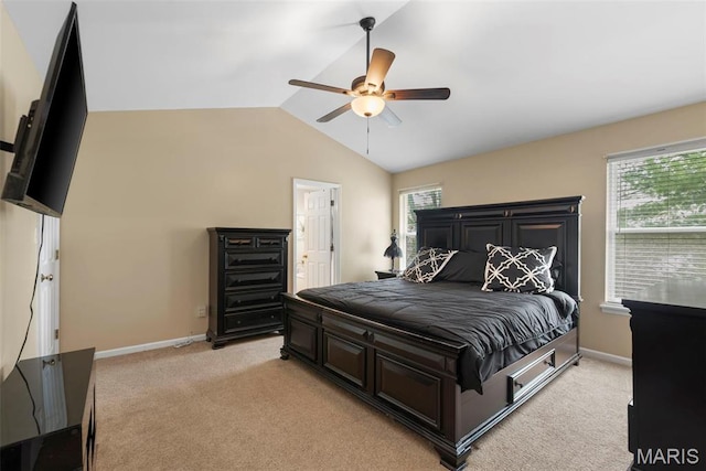 bedroom featuring light colored carpet, lofted ceiling, multiple windows, baseboards, and ceiling fan