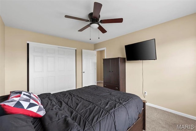 carpeted bedroom with baseboards, a closet, and ceiling fan
