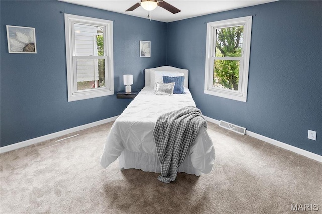 2619 Plainview Ter, Alton, IL 62002 - carpeted bedroom featuring multiple windows, baseboards, and ceiling fan