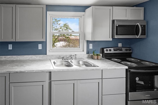 2619 Plainview Ter, Alton, IL 62002 - kitchen featuring appliances with stainless steel finishes, a sink, and light countertops