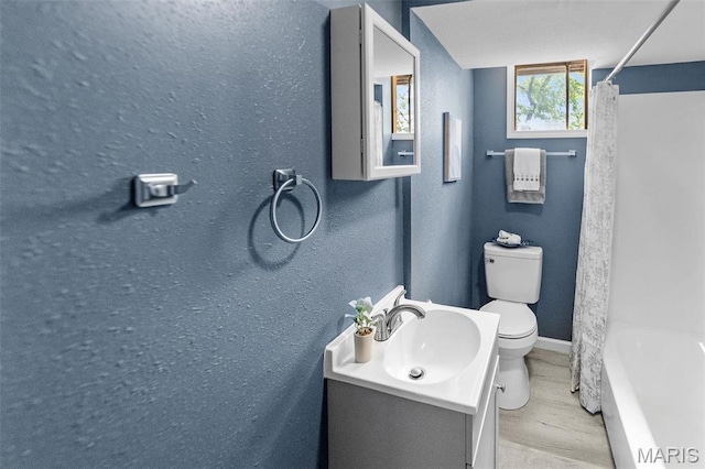 2619 Plainview Ter, Alton, IL 62002 - full bathroom with toilet, wood finished floors, vanity, baseboards, and a textured wall
