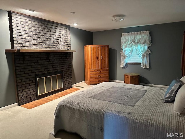 109 Link Dr, Sikeston, MO 63801 - bedroom featuring a brick fireplace, carpet floors, and baseboards