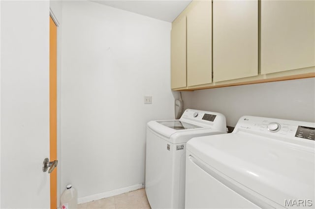 1626 Viola Dr, Imperial, MO 63052 - washroom featuring washing machine and dryer, cabinet space, baseboards, and light tile patterned floors