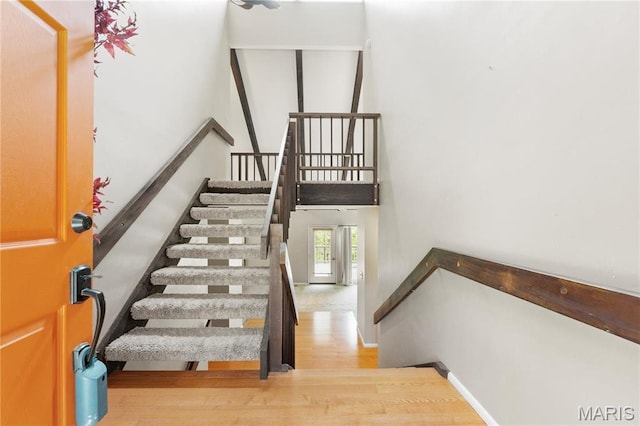 1626 Viola Dr, Imperial, MO 63052 - stairs featuring wood finished floors, baseboards, and a towering ceiling