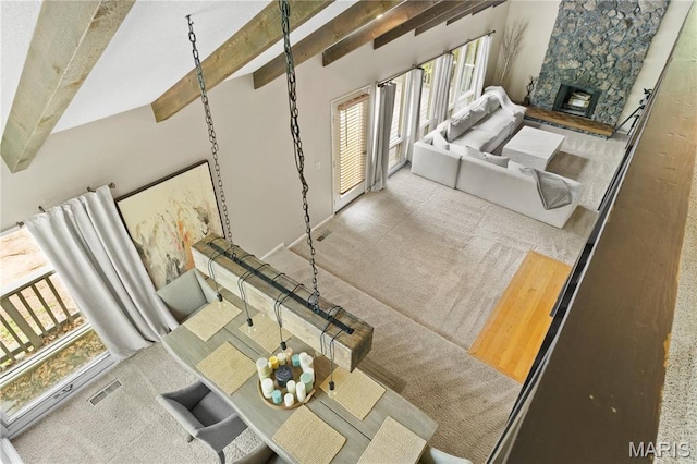 1626 Viola Dr, Imperial, MO 63052 - carpeted living area with a stone fireplace and beamed ceiling