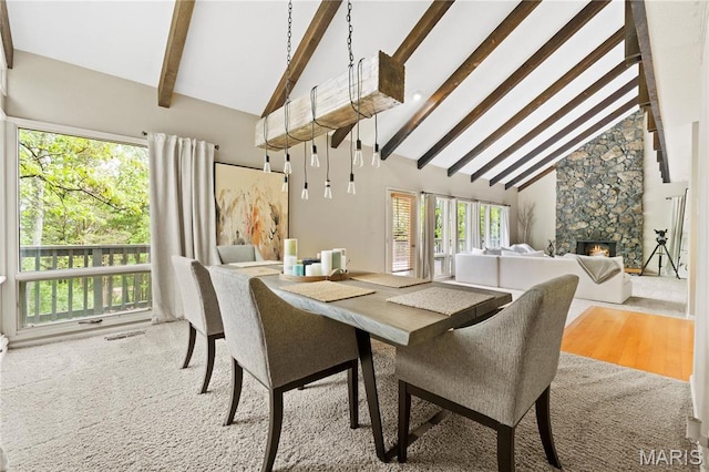 1626 Viola Dr, Imperial, MO 63052 - dining space featuring high vaulted ceiling, beam ceiling, healthy amount of natural light, a fireplace, and wood finished floors