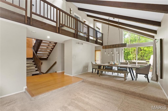 1626 Viola Dr, Imperial, MO 63052 - carpeted dining space with high vaulted ceiling, baseboards, stairway, and beamed ceiling