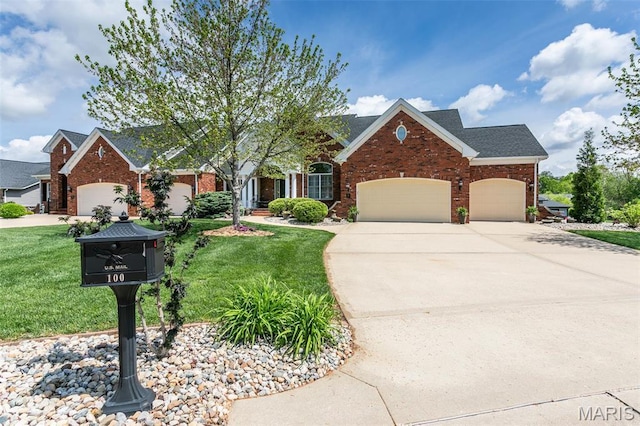 100 Waterfall Ct, Glen Carbon, IL 62034 - traditional home with an attached garage, brick siding, concrete driveway, and a front lawn