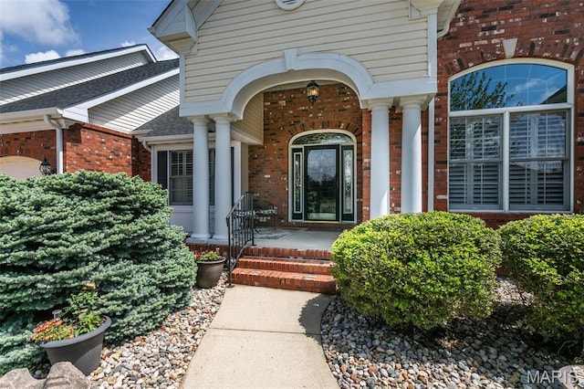 100 Waterfall Ct, Glen Carbon, IL 62034 - entrance to property with brick siding, covered porch, and an attached garage