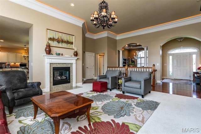 100 Waterfall Ct, Glen Carbon, IL 62034 - living area with arched walkways, ornate columns, a chandelier, ornamental molding, and recessed lighting