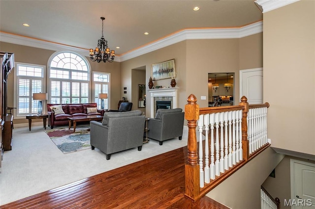 100 Waterfall Ct, Glen Carbon, IL 62034 - carpeted living area featuring ornamental molding, a chandelier, a fireplace, recessed lighting, and wood finished floors
