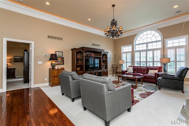 100 Waterfall Ct, Glen Carbon, IL 62034 - living room featuring ornamental molding, a chandelier, recessed lighting, baseboards, and light wood-style flooring
