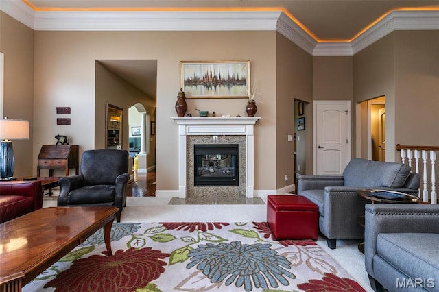 100 Waterfall Ct, Glen Carbon, IL 62034 - living area with crown molding, arched walkways, a fireplace, baseboards, and wood finished floors