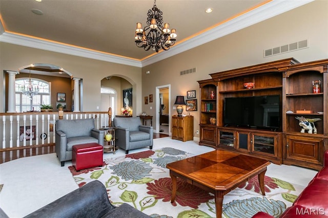 100 Waterfall Ct, Glen Carbon, IL 62034 - living area featuring a chandelier, arched walkways, carpet, crown molding, and decorative columns