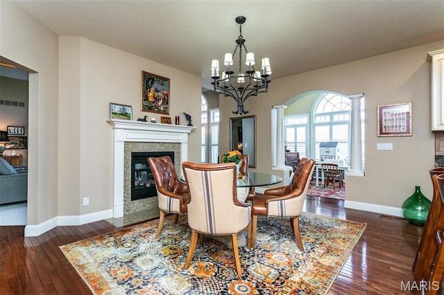 100 Waterfall Ct, Glen Carbon, IL 62034 - dining room featuring decorative columns, a high end fireplace, baseboards, and dark wood finished floors