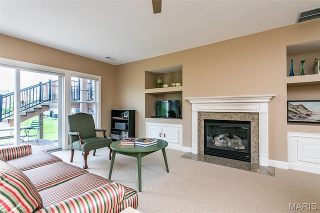 100 Waterfall Ct, Glen Carbon, IL 62034 - carpeted living area featuring built in features, ceiling fan, a premium fireplace, and baseboards