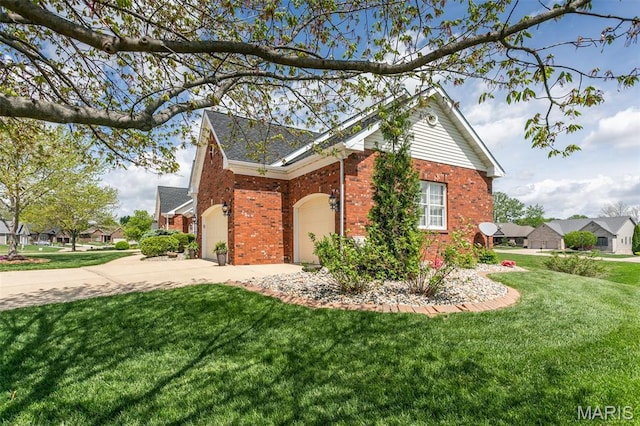 100 Waterfall Ct, Glen Carbon, IL 62034 - view of property exterior with driveway, brick siding, a lawn, and a garage