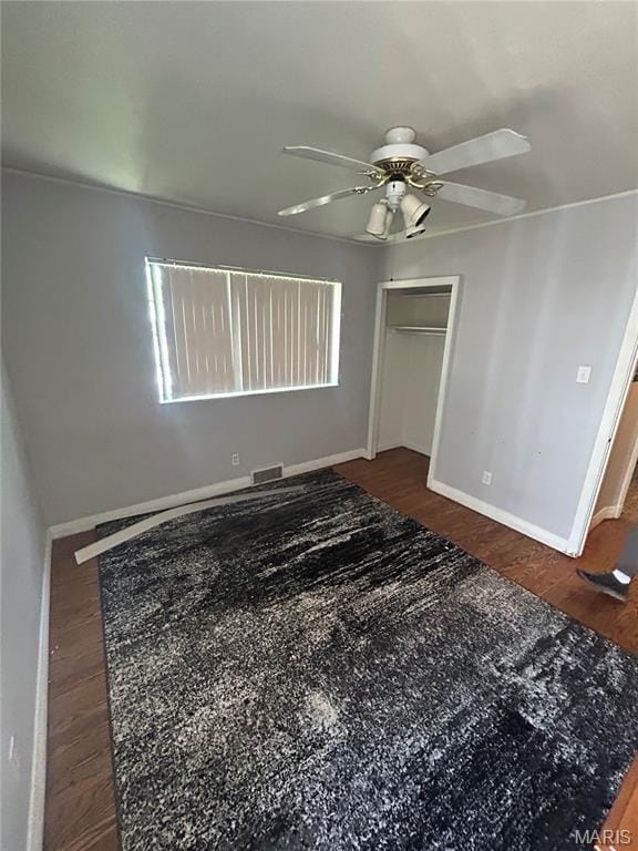 943 Warder Ave, Saint Louis, MO 63130 - unfurnished bedroom featuring baseboards, wood finished floors, a ceiling fan, and a closet
