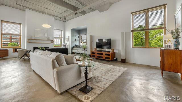 4100 Laclede Ave Unit 314, Saint Louis, MO 63108 - living room featuring a fireplace and finished concrete floors