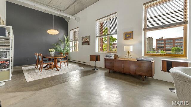 4100 Laclede Ave Unit 314, Saint Louis, MO 63108 - dining room with a towering ceiling, concrete floors, and a baseboard heating unit