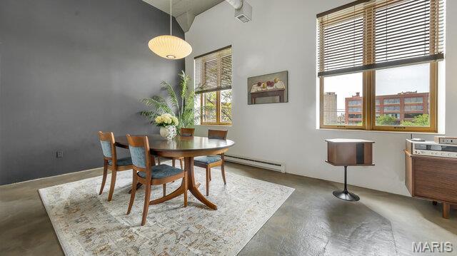 4100 Laclede Ave Unit 314, Saint Louis, MO 63108 - dining area featuring concrete flooring, a baseboard radiator, and a high ceiling