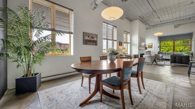 4100 Laclede Ave Unit 314, Saint Louis, MO 63108 - dining area with a baseboard radiator, a high ceiling, and wooden ceiling