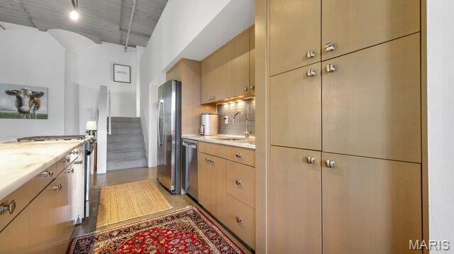 4100 Laclede Ave Unit 314, Saint Louis, MO 63108 - kitchen featuring appliances with stainless steel finishes, a sink, light countertops, and decorative backsplash