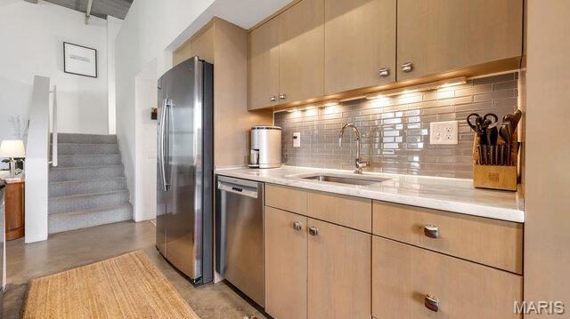 4100 Laclede Ave Unit 314, Saint Louis, MO 63108 - kitchen featuring appliances with stainless steel finishes, a sink, light countertops, tasteful backsplash, and concrete floors