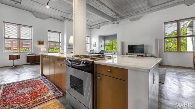 4100 Laclede Ave Unit 314, Saint Louis, MO 63108 - kitchen featuring stainless steel range with gas cooktop, track lighting, concrete floors, and open floor plan
