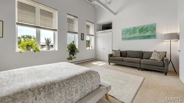 4100 Laclede Ave Unit 314, Saint Louis, MO 63108 - carpeted bedroom featuring a baseboard heating unit, a high ceiling, and a closet