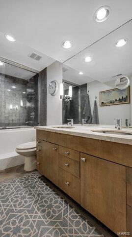 4100 Laclede Ave Unit 314, Saint Louis, MO 63108 - full bathroom featuring double vanity, recessed lighting, washtub / shower combination, and toilet