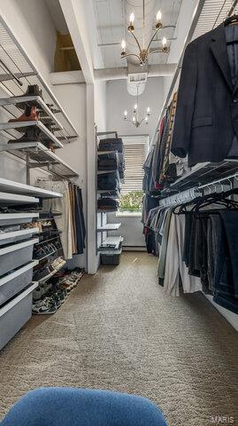 4100 Laclede Ave Unit 314, Saint Louis, MO 63108 - spacious closet featuring a chandelier and carpet flooring