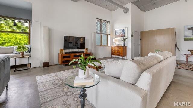 4100 Laclede Ave Unit 314, Saint Louis, MO 63108 - living area featuring a high ceiling, finished concrete flooring, and beamed ceiling
