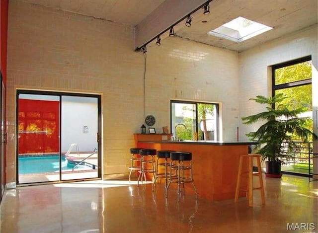 4100 Laclede Ave Unit 314, Saint Louis, MO 63108 - indoor dry bar with a high ceiling, finished concrete floors, and track lighting