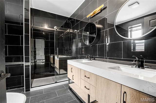 4402 Arco Ave, Saint Louis, MO 63110 - bathroom with tile walls, tile patterned flooring, a shower stall, double vanity, and decorative backsplash