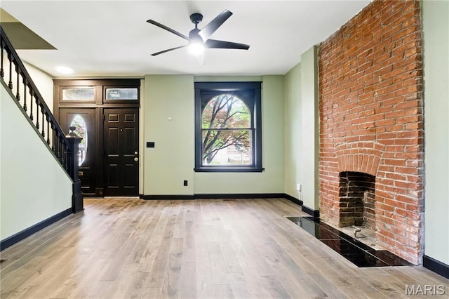 4402 Arco Ave, Saint Louis, MO 63110 - unfurnished living room with stairs, wood finished floors, baseboards, and a ceiling fan