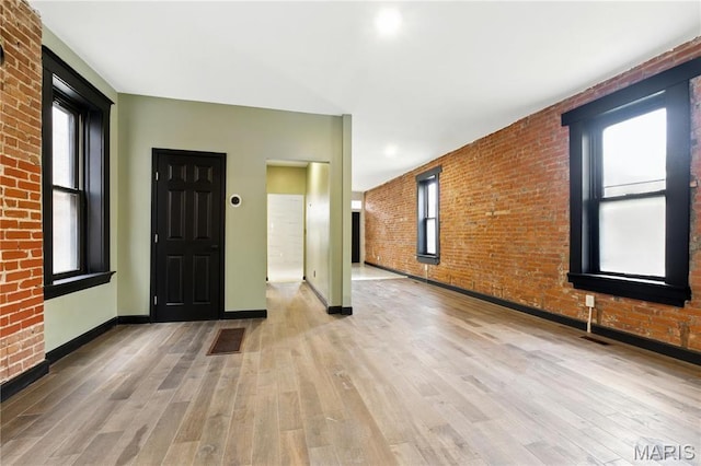 4402 Arco Ave, Saint Louis, MO 63110 - entrance foyer featuring wood finished floors, brick wall, and baseboards