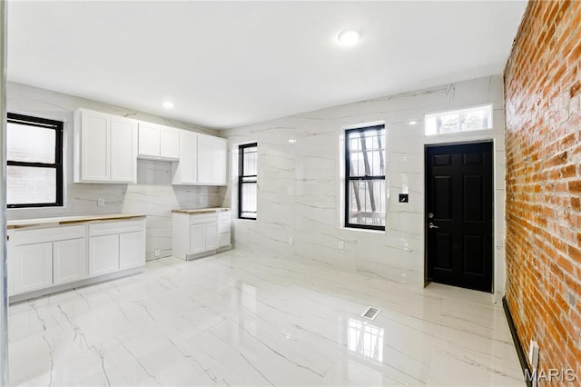 4402 Arco Ave, Saint Louis, MO 63110 - foyer entrance with light marble finish floors and brick wall
