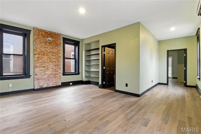 4402 Arco Ave, Saint Louis, MO 63110 - spare room with light wood-style flooring, baseboards, and built in features