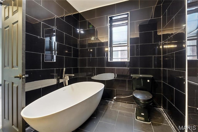 4402 Arco Ave, Saint Louis, MO 63110 - full bathroom featuring tile walls, a freestanding tub, toilet, and tile patterned flooring
