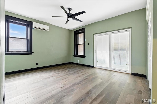 4402 Arco Ave, Saint Louis, MO 63110 - unfurnished bedroom with a wall mounted AC, wood finished floors, baseboards, access to exterior, and a ceiling fan