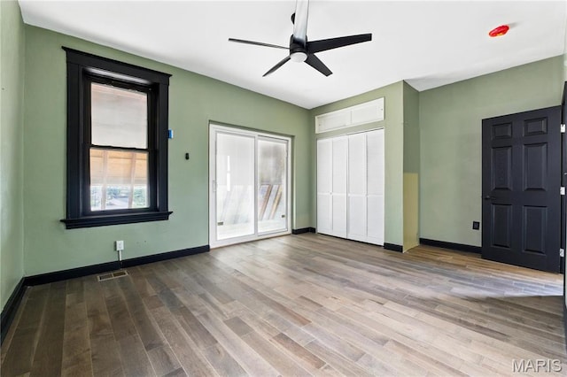 4402 Arco Ave, Saint Louis, MO 63110 - unfurnished bedroom with wood finished floors, baseboards, and ceiling fan